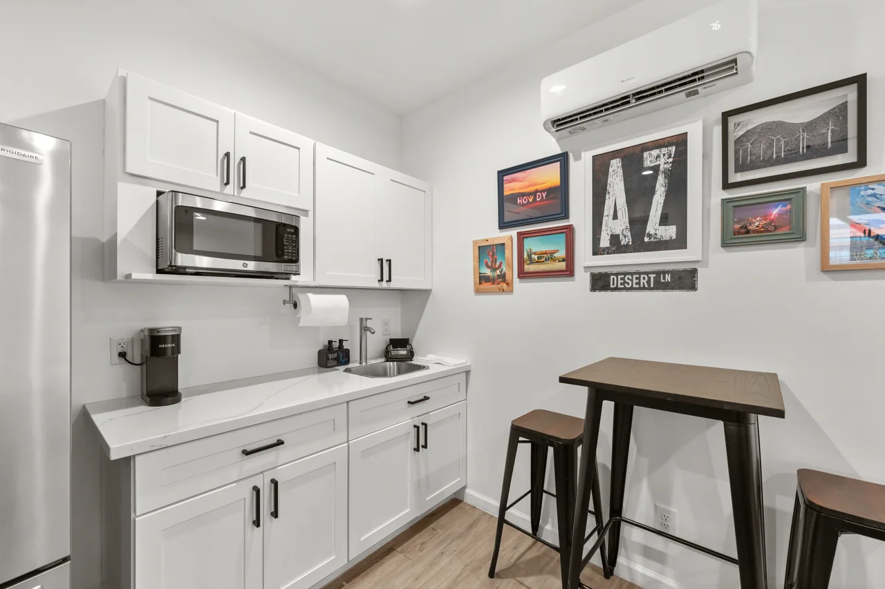 Desert kitchenette with a fridge, microwave and counter space