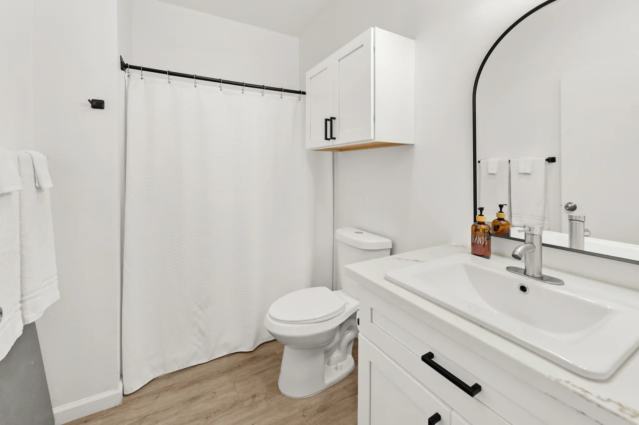 River bathroom with a sink, mirror and shower curtain