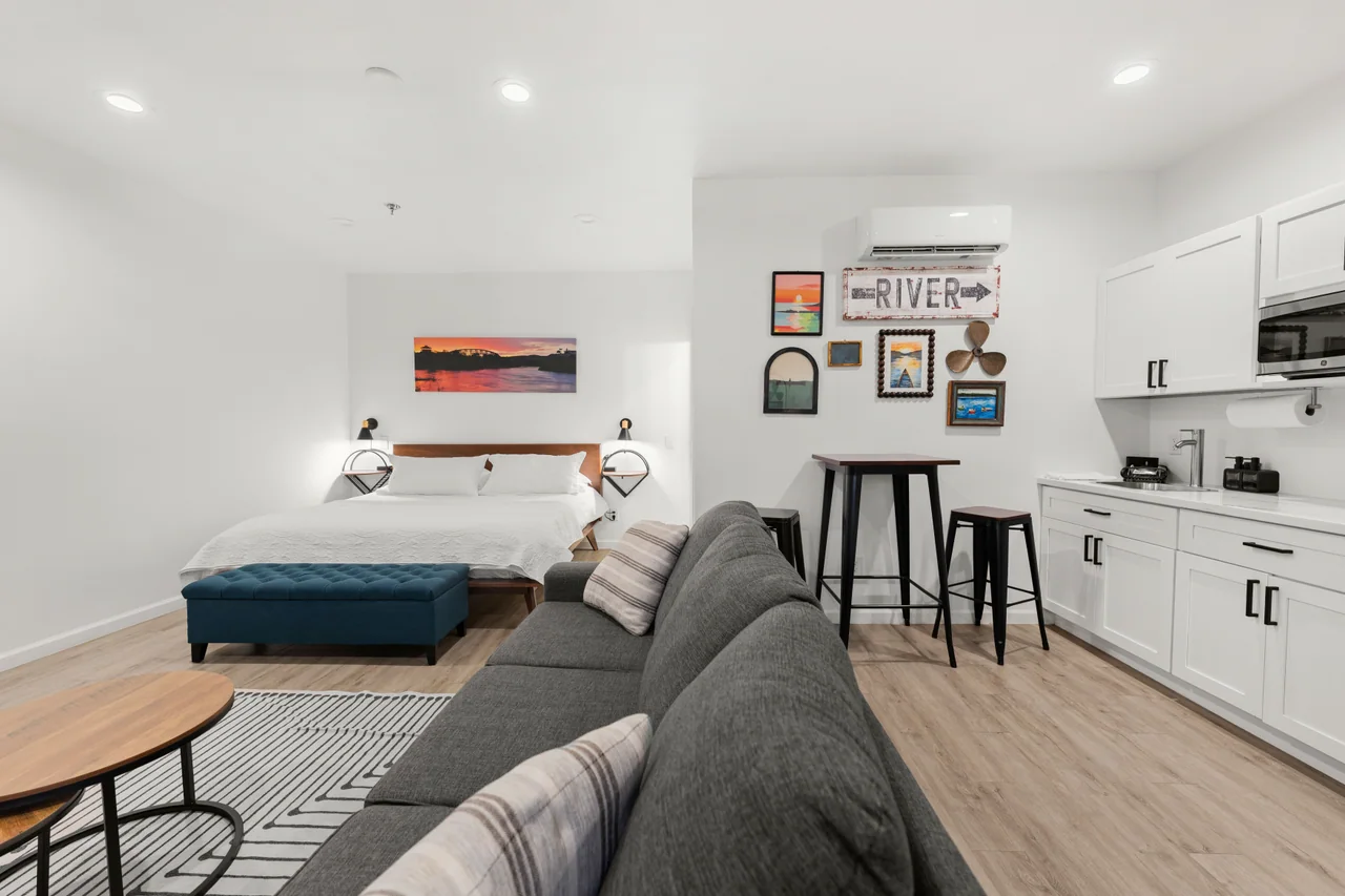 The River Retreat studio with a king bed, sofa and river-themed artwork